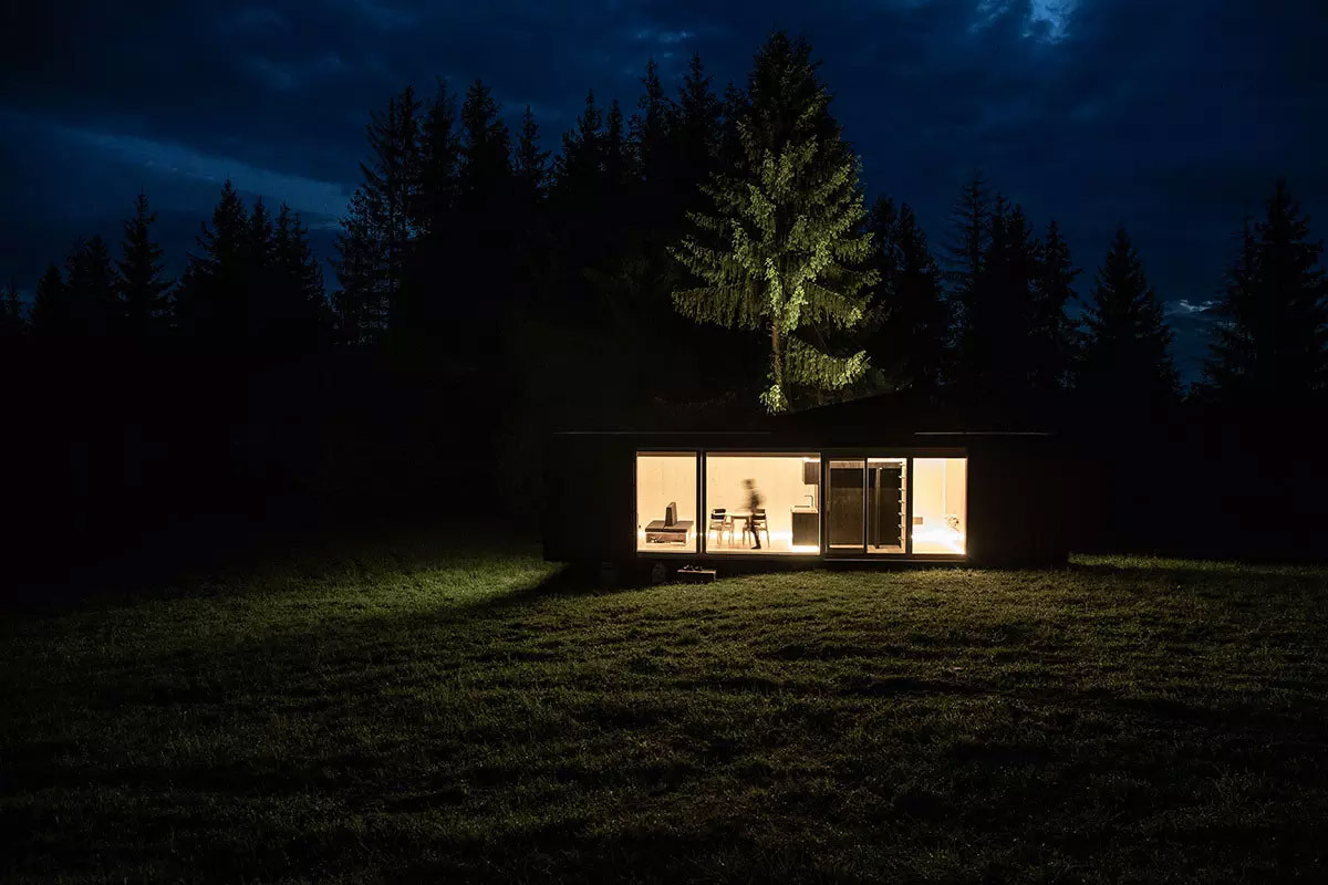 ARK-Shelter cabin exterior in a forest setting, published by ARK-Shelter