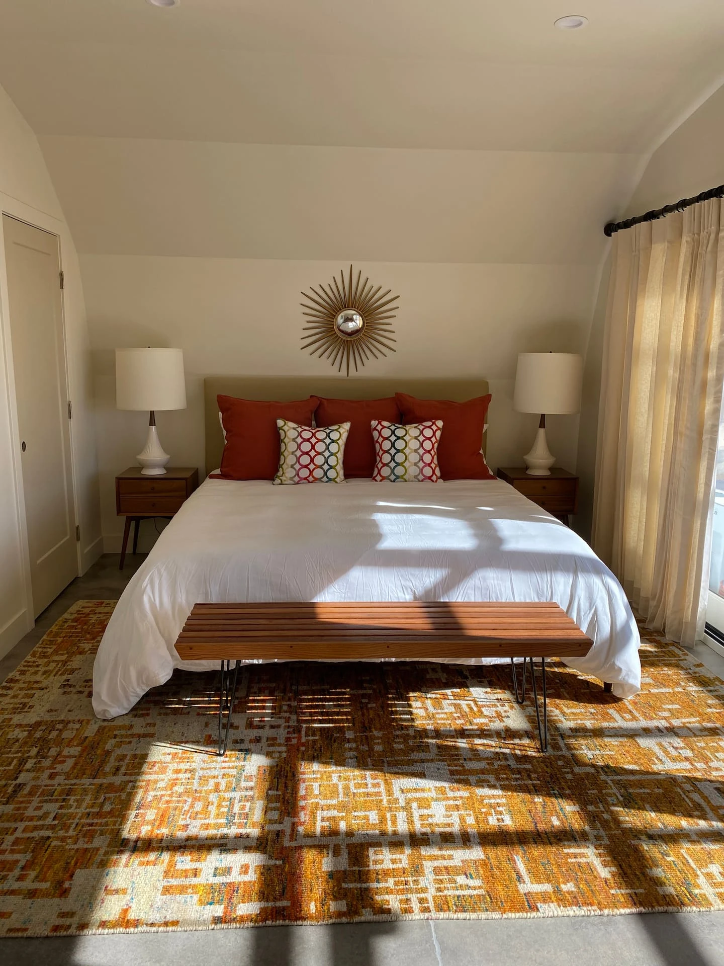 Bed and bedside tables inside the Rhumb Line Vineyard studio.