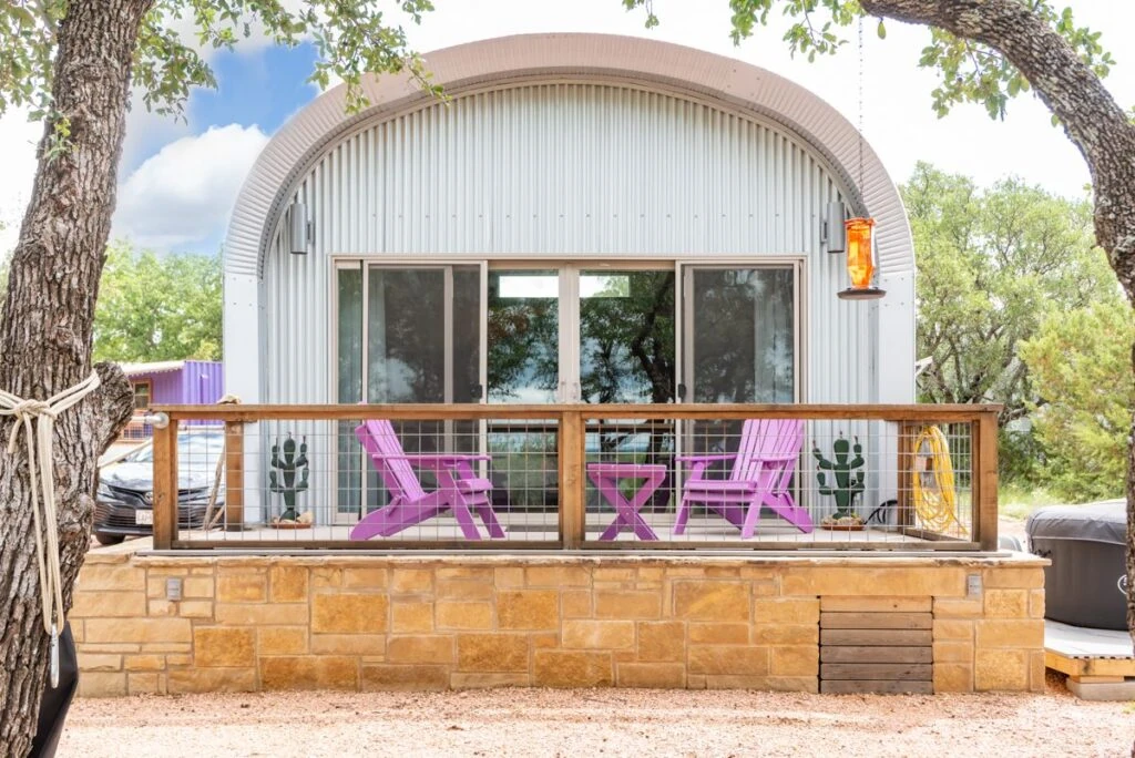 Steel arch casita with a masonry base and purple porch chairs at Rockin' H Lavender Farm.