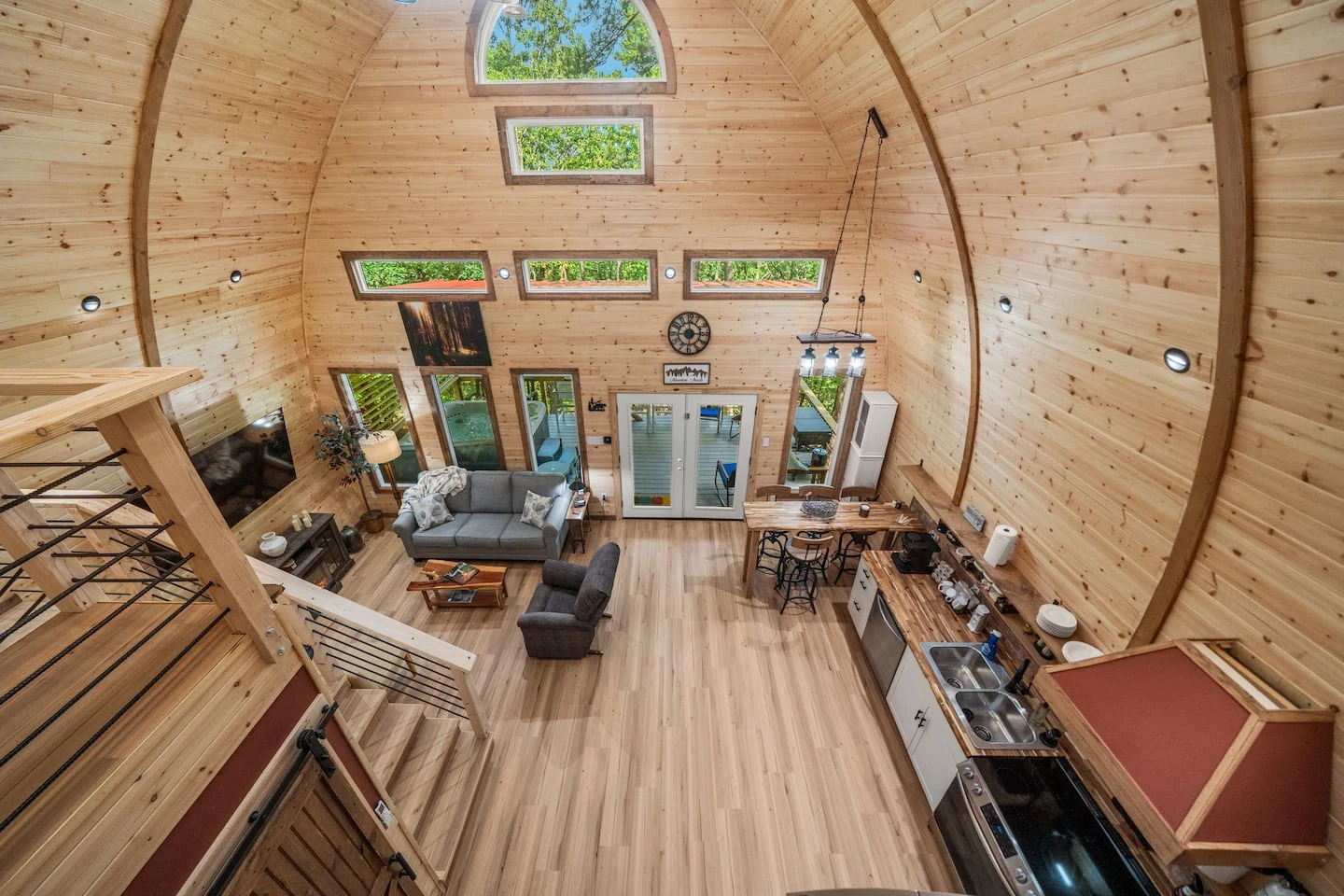 View from a loft into the wood finished living room of the Hot Springs cabin.