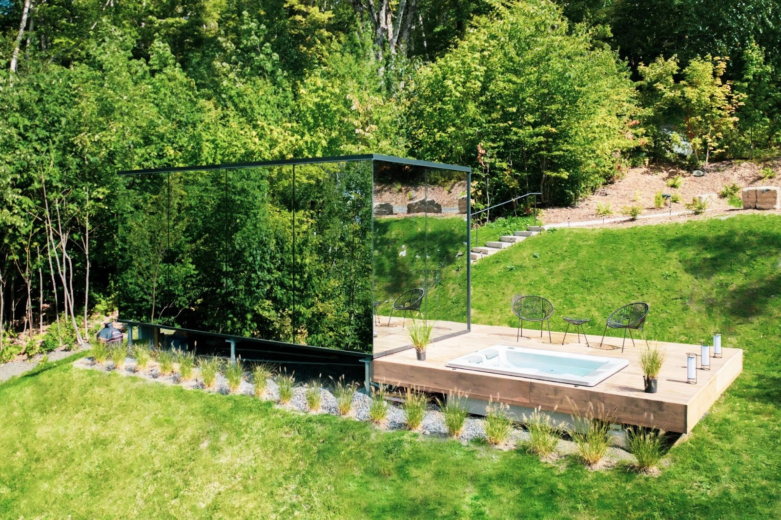 Mirror house reflecting trees on a hillside in Warren, Vermont.