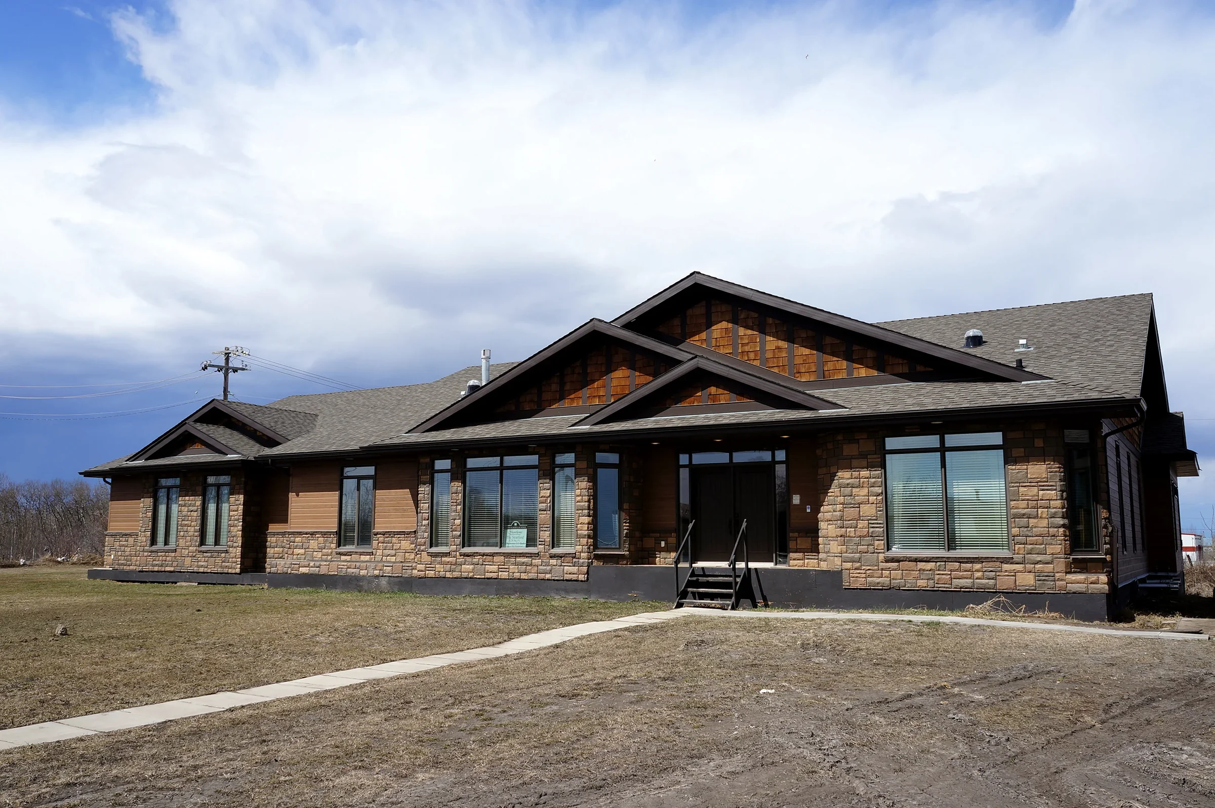 Western Modular Homes Stratford model exterior with stone and wood finishes