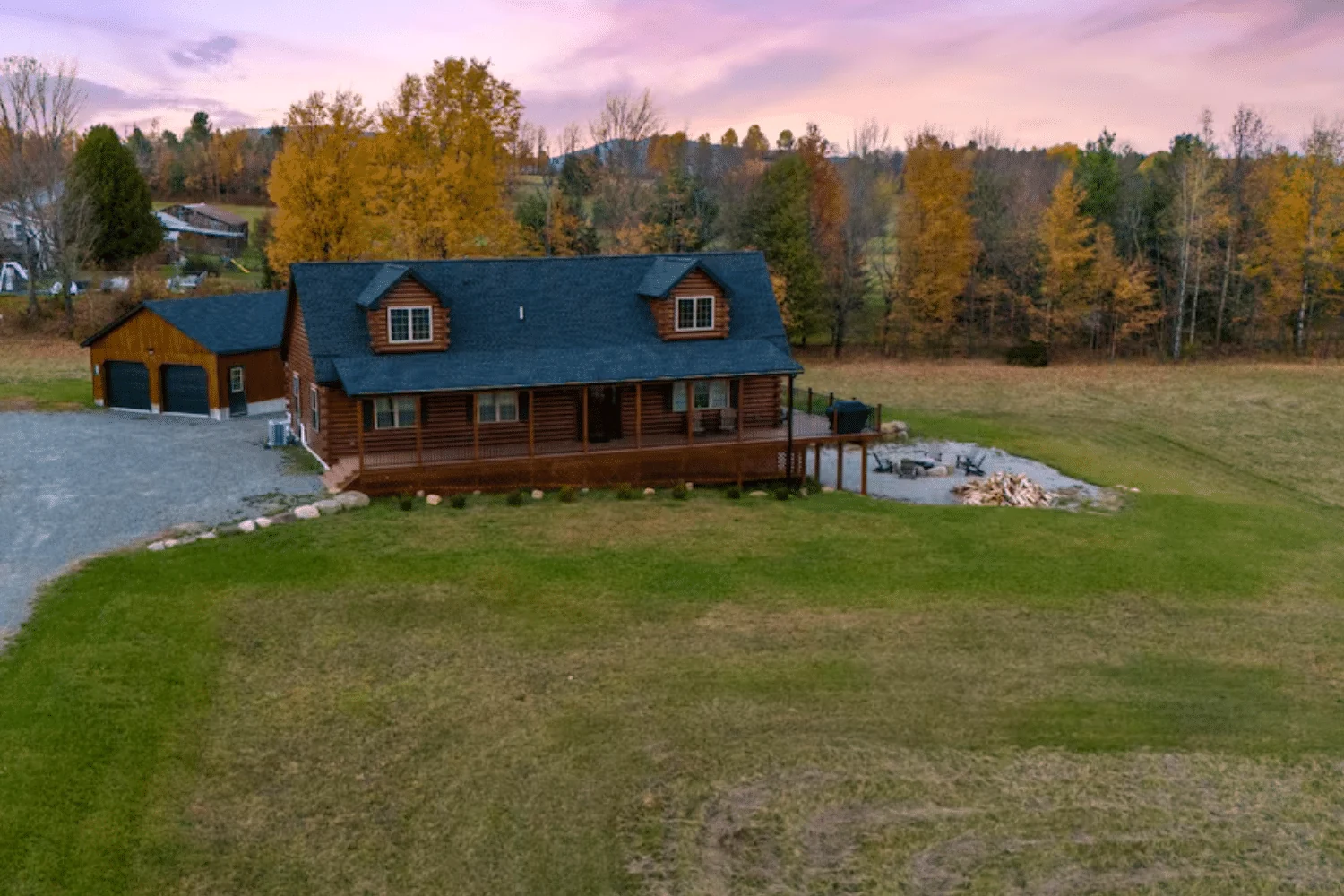 A completed Mountaineer Deluxe log cabin with a covered porch in Vermontville, New York.